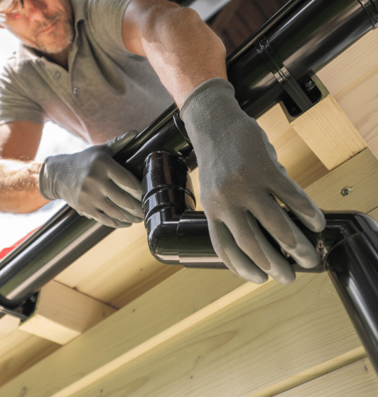 Person installing downspout. 