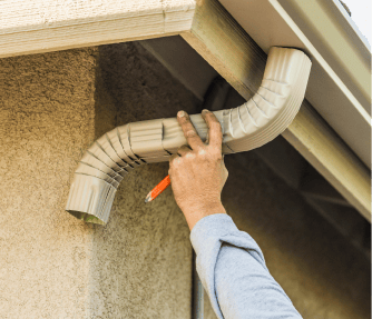 Man holding gutter spout.
